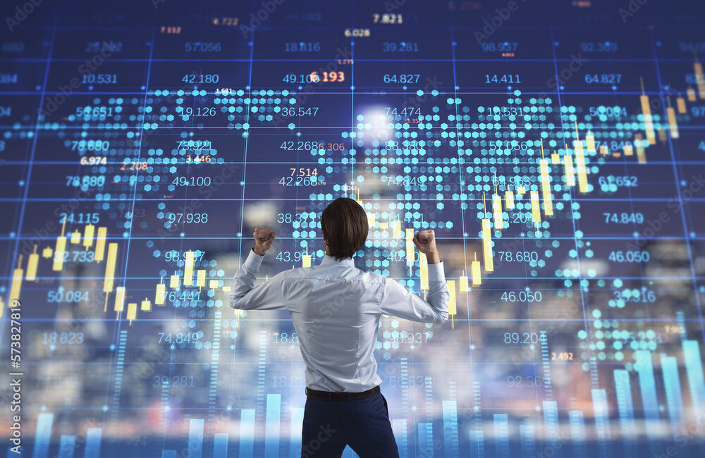 Back view of young european businessman celebrating success on illuminated blurry night city background with forex chart. Triumph and lifestyle concept. Trade and financial market interest.